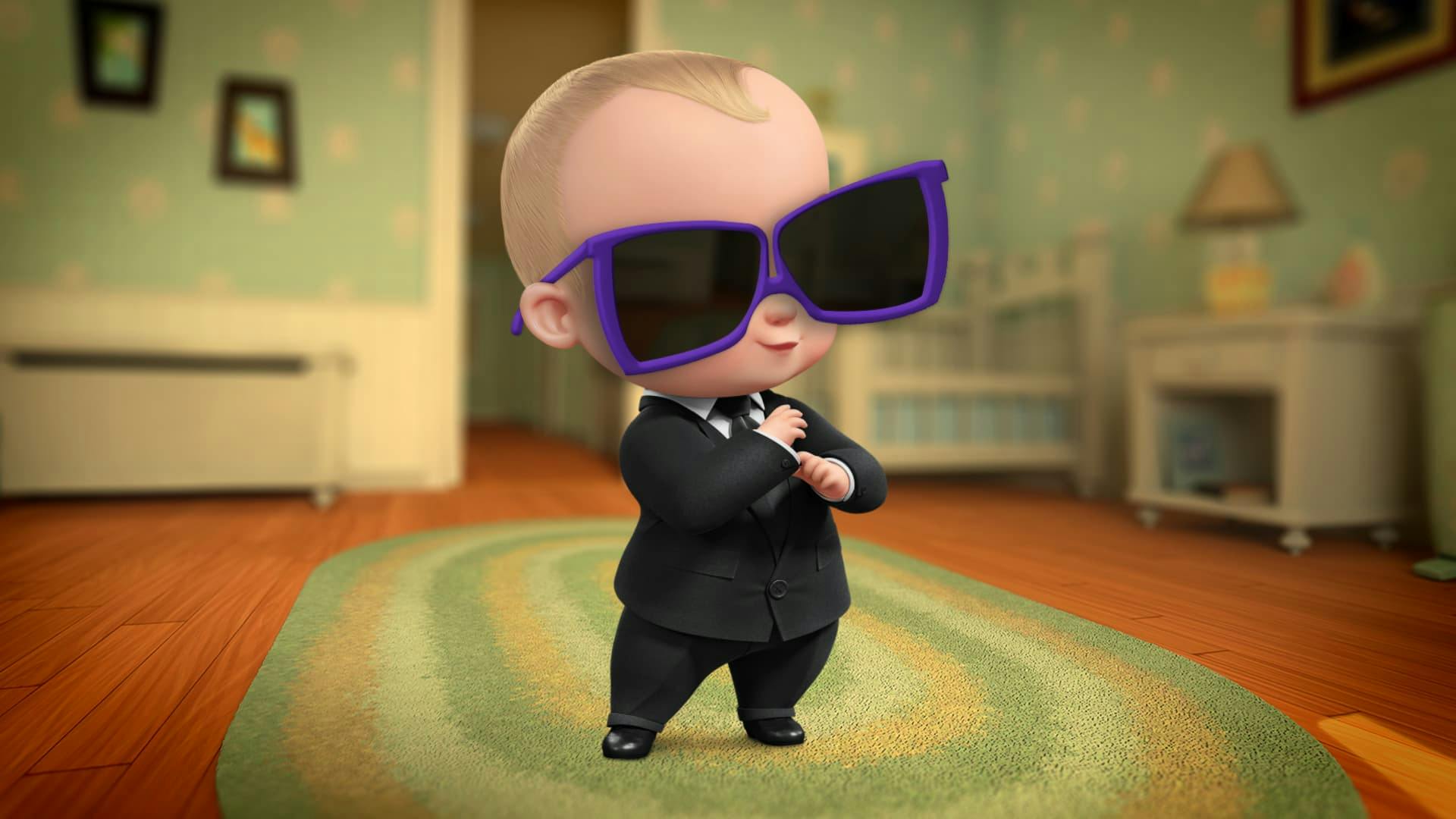 DreamWorks Boss Baby stand in a bedroom wearing over-sized purple framed sunglasses obscuring his eyes from view.