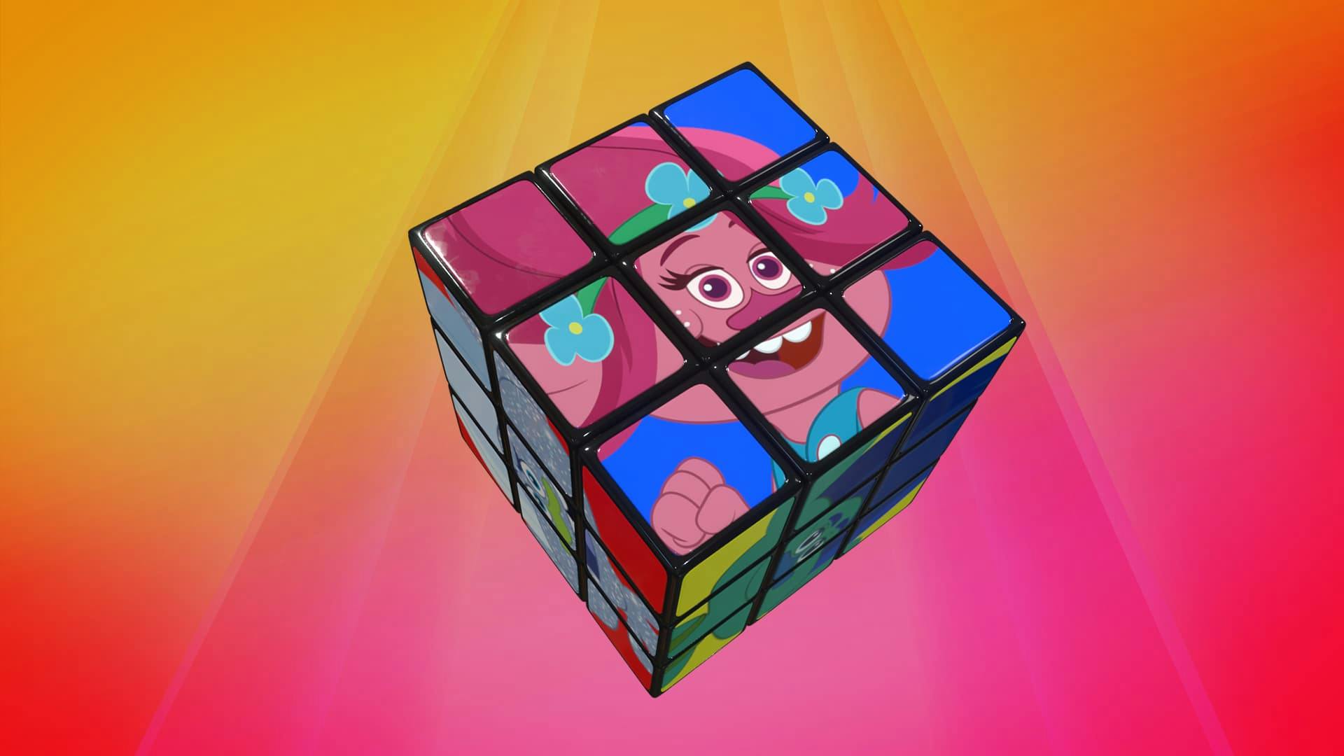 A rubiks cube sits in front of a colourful background, the faces of the cube have popular characters from the DreamWorks TV show Trolls.